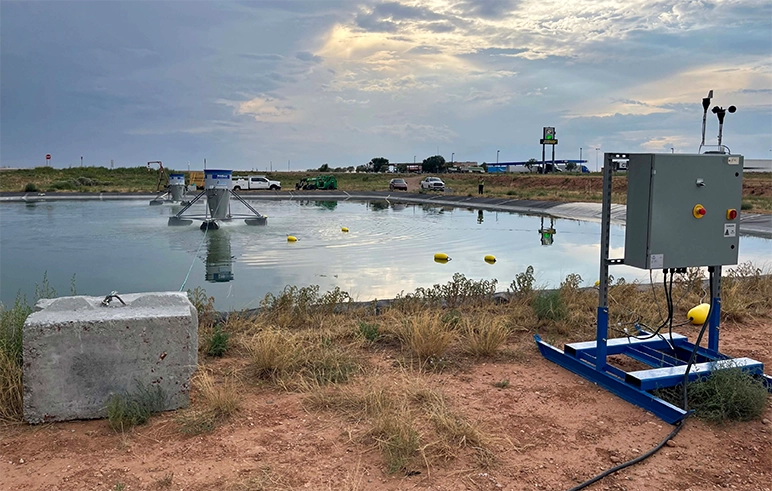 Evaporative lagoon with large pool of water and equipment