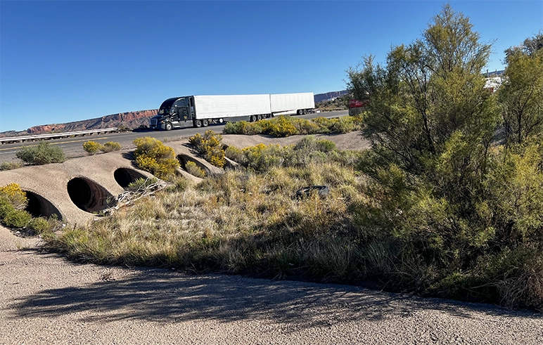 Travel center with truck driving over raised road
